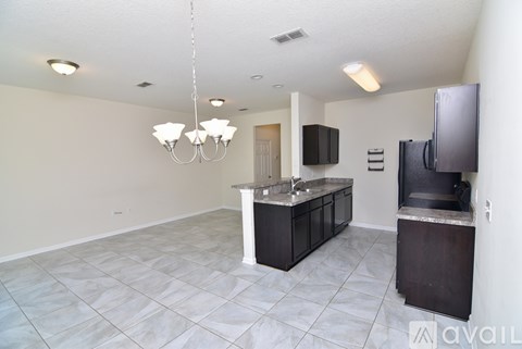 A kitchen with a black counter and a white ceiling.