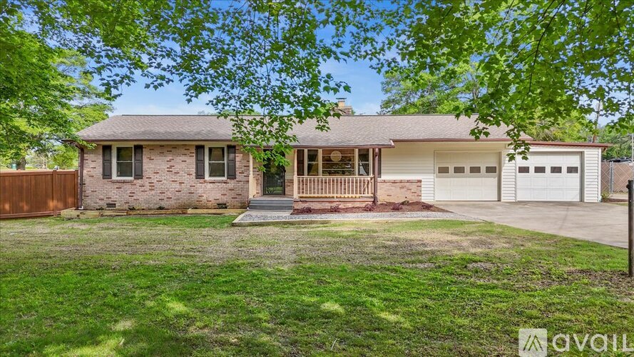 A house with a front yard and a garage is for sale.