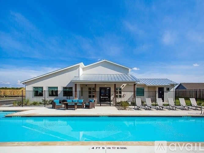 A house with a pool in front of it.