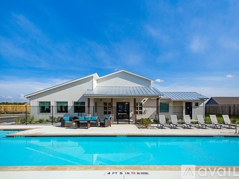 A house with a pool in front of it.