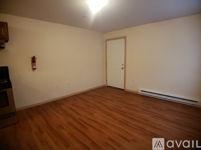 A room with wooden floors and a white door.