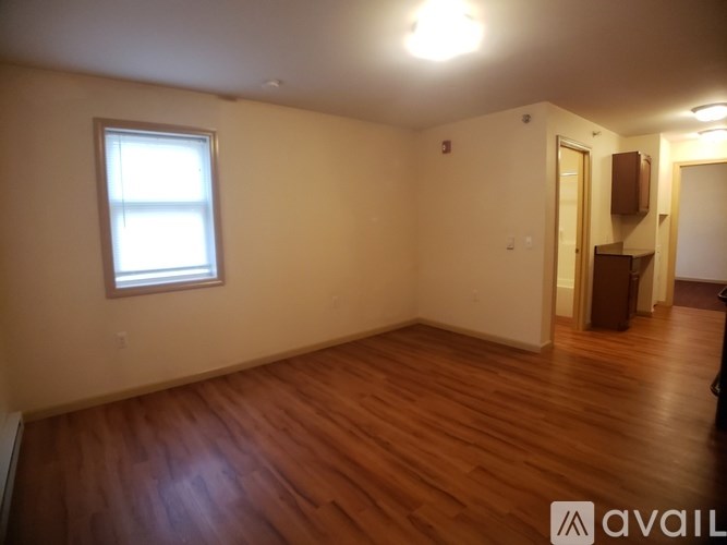 A room with wooden floors and a window.