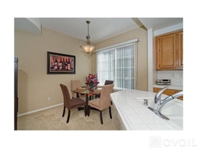 A kitchen with a table and chairs in the middle of the room.