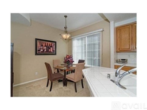 A kitchen with a table and chairs in the middle of the room.