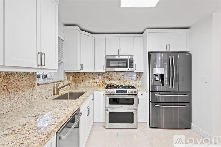 A kitchen with granite countertops and stainless steel appliances.