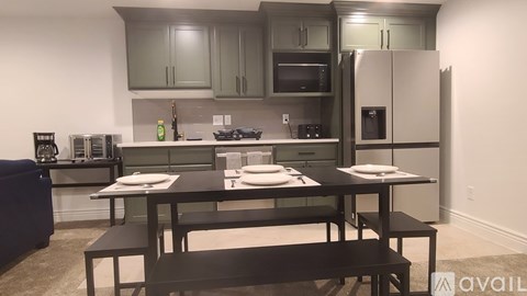 A kitchen with a table set for two.