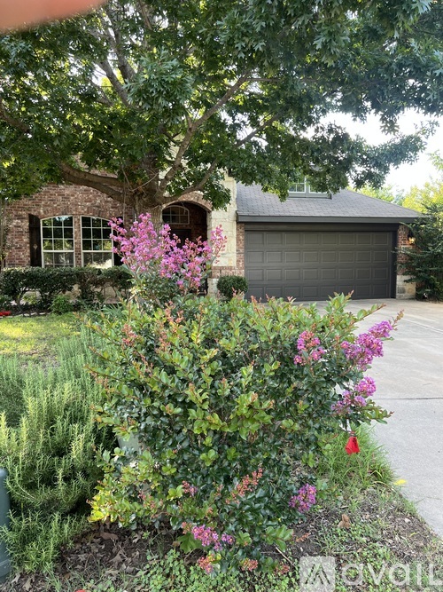 A house with a garage and a driveway is available for sale.