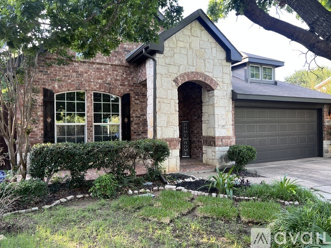 A house with a garage and a driveway.