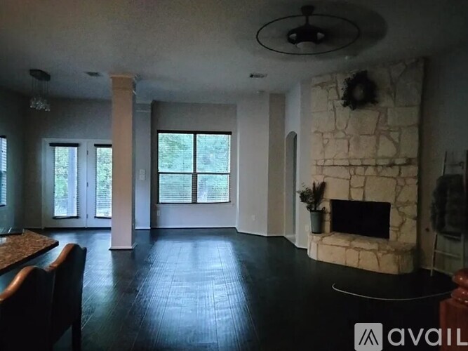 A living room with a fireplace and a dining table.
