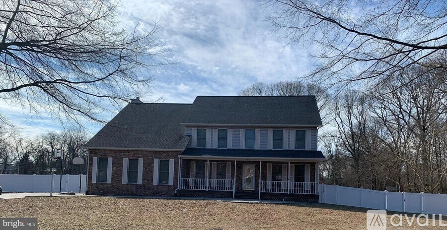 A house with a white picket fence in front of it.