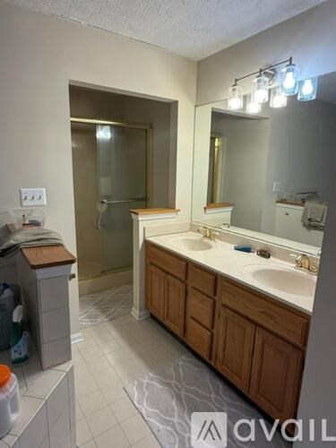 A bathroom with a white sink and a mirror.