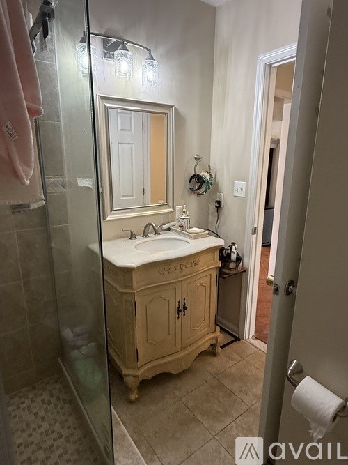 A bathroom with a sink and a mirror.