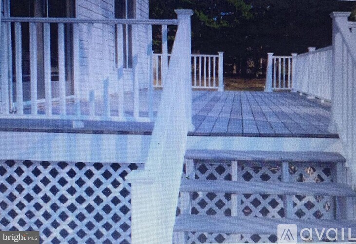 A porch with a lattice design on the bottom.