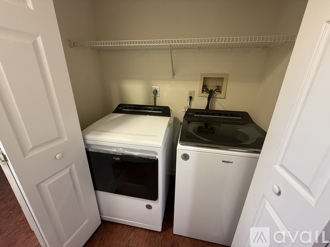 A small kitchen with a white oven and a white fridge.
