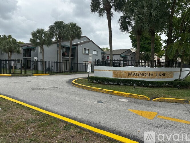 A street view of Magnolia Lane with houses and palm trees.