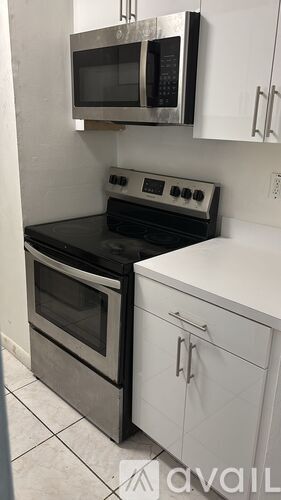 A kitchen with a blue stove top oven and a microwave above it.