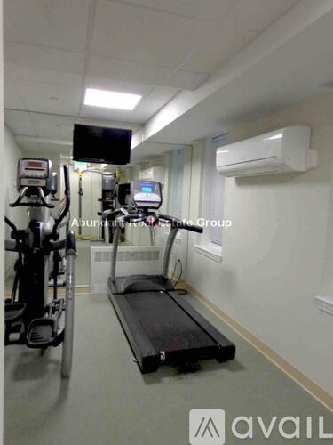 A gym room with a treadmill, exercise bike and other equipment.