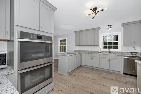 A modern kitchen with a large oven and a microwave.