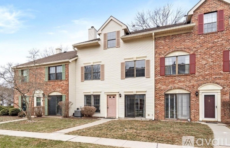 A two-story house with a brick facade and a white front.
