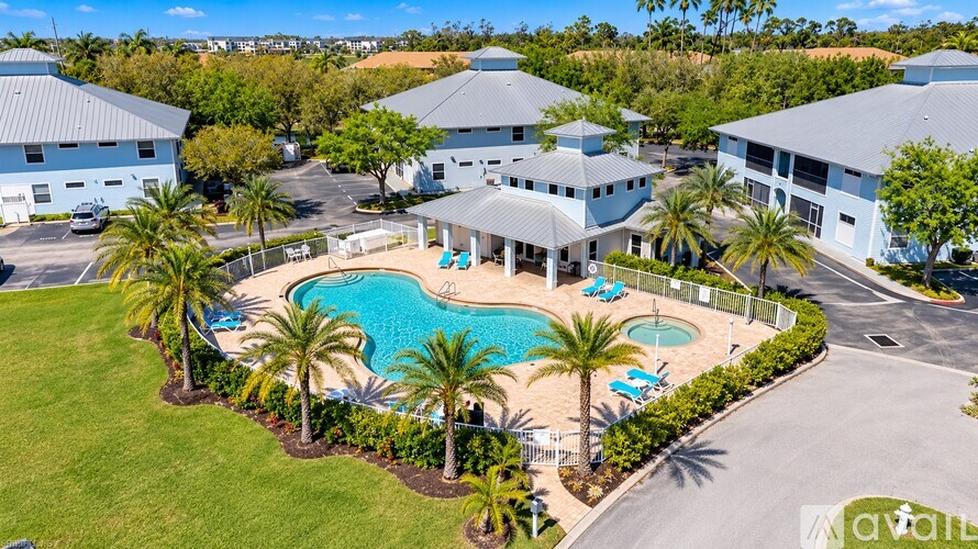 A large building with a pool in front of it.