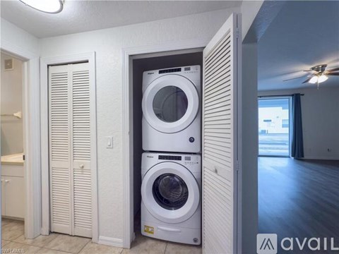A stacked washer and dryer in a laundry room.