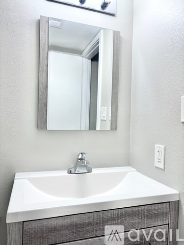 A white sink with a wooden drawer underneath it.