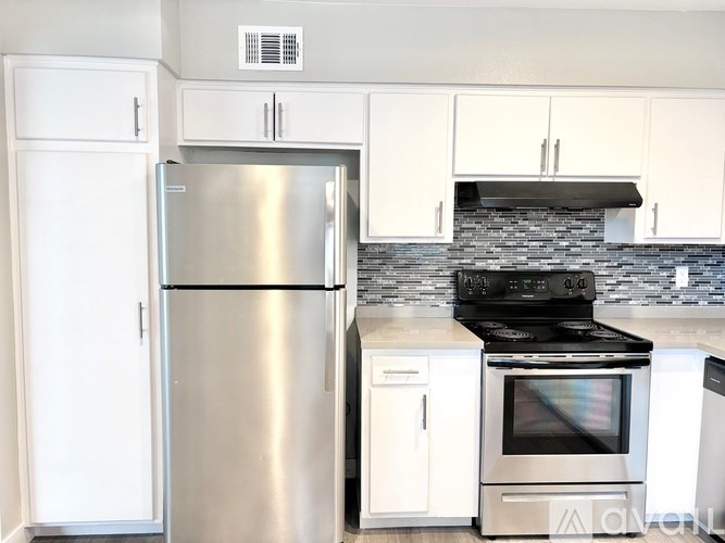 A kitchen with a stainless steel refrigerator and oven.