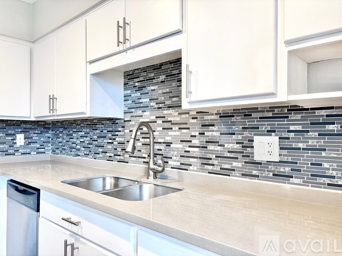 A kitchen with a sink and a dishwasher.