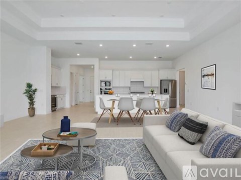 A modern living room with a white sofa and a coffee table.