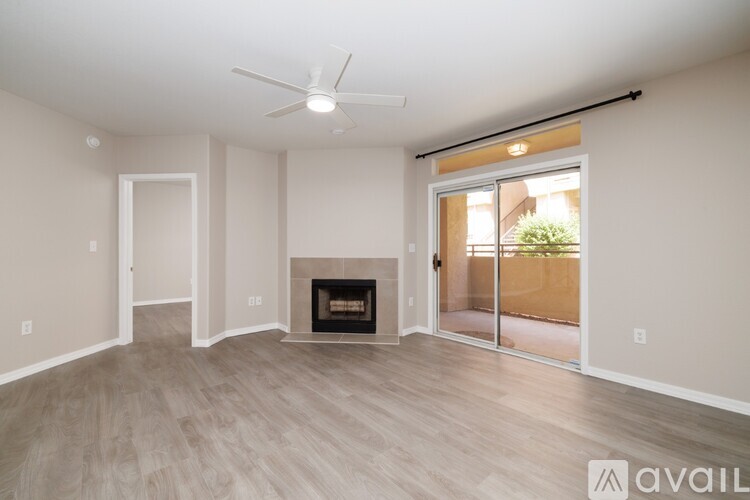 A spacious living room with a fireplace and sliding glass doors.