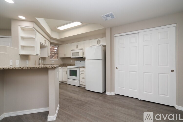 A kitchen with a dining table and chairs.