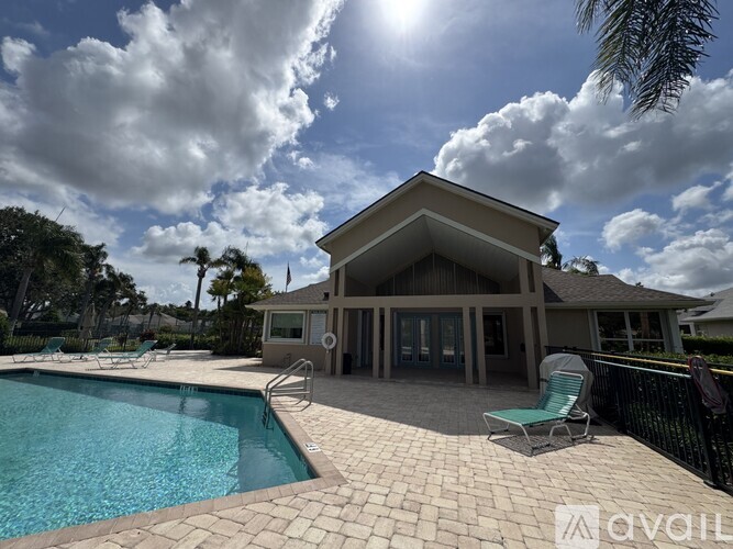 A house with a pool in front of it.
