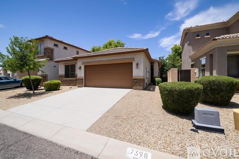 A house with a driveway and garage in front of it.