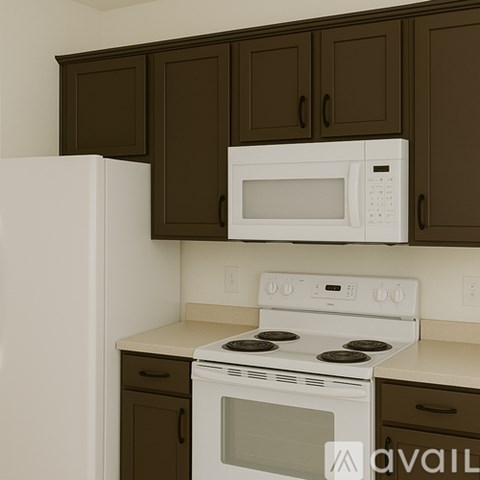 A white microwave oven is mounted above a white stove in a kitchen.
