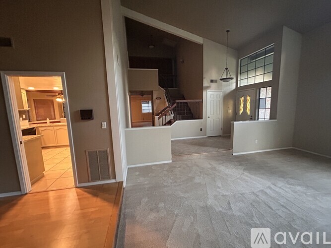 A spacious room with a doorway leading to another room.