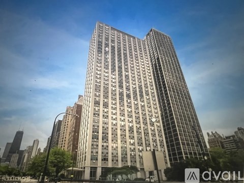 A tall building with many windows is in the foreground.