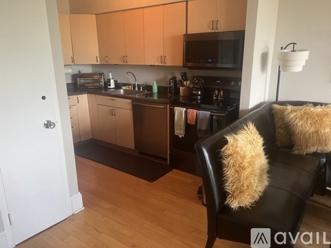 A kitchen with a black chair and a white door.