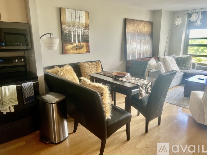 A modern living room with a black sofa and a wooden coffee table.