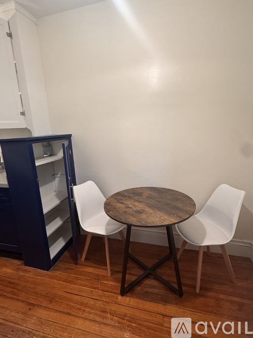 A kitchen with a white oven and blue cabinetry.