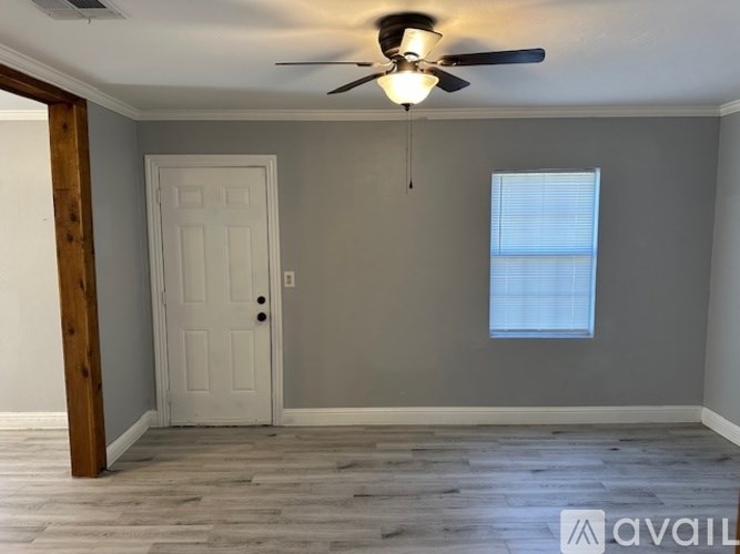 A room with a white door and a window with blinds.