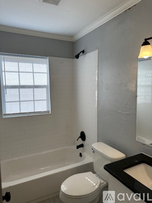 A bathroom with a white toilet and a bathtub.