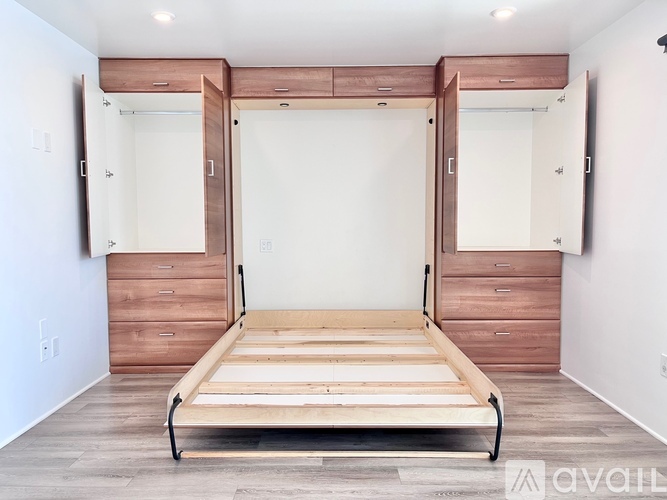 A bedroom with a bed, dresser, and mirror.