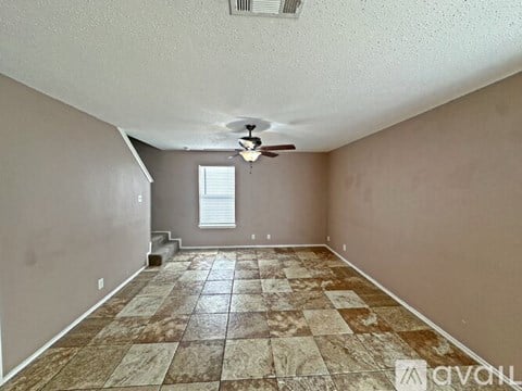 A kitchen with granite countertops and tile flooring.