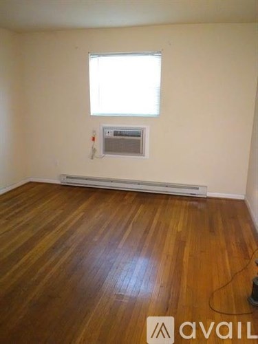 A room with wooden floors and a window.