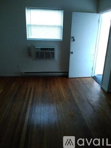 A room with wooden floors and a window.