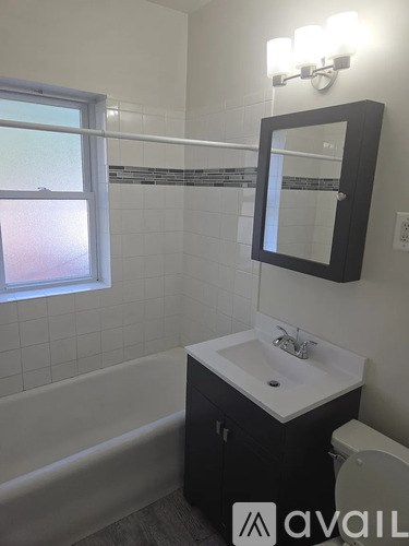A bathroom with a sink, toilet and bathtub.