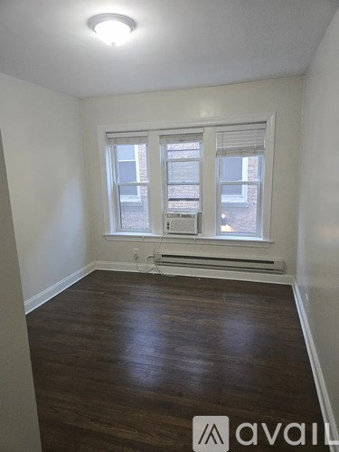 A room with a window and a radiator on the wall.