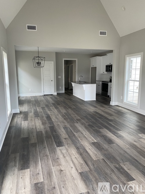 A spacious kitchen with a large island and a dining area.