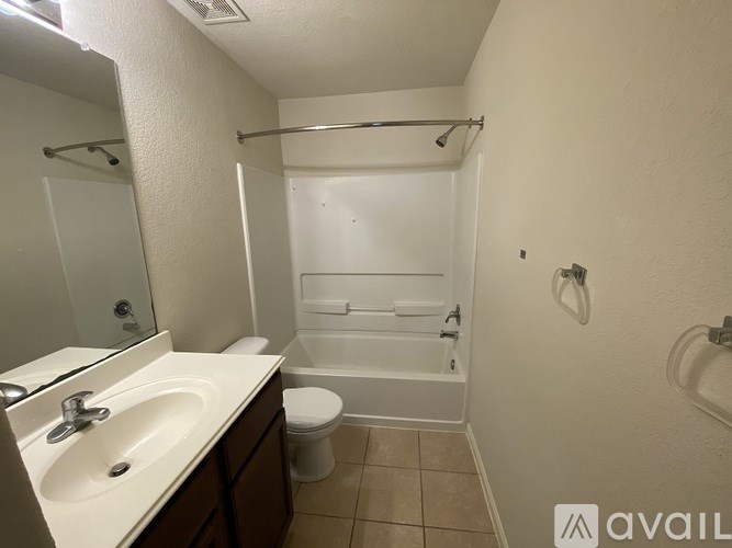 A bathroom with a toilet, sink, and bathtub.