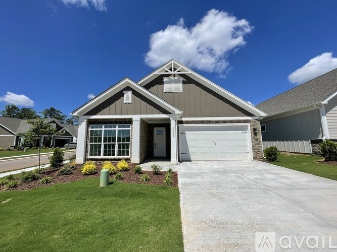 A house with a garage and a driveway in front.
